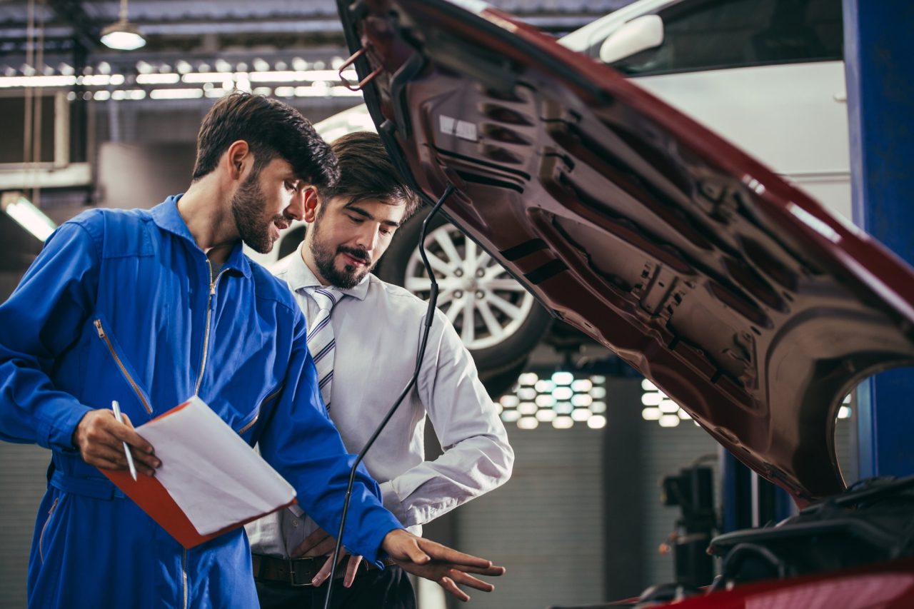 Automotive maintenance mechanic explain repair condition to customer.jpg