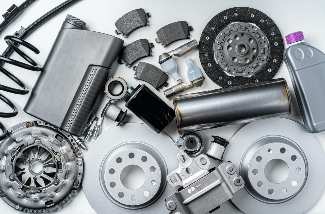 New metal auto parts on grey background.jpg