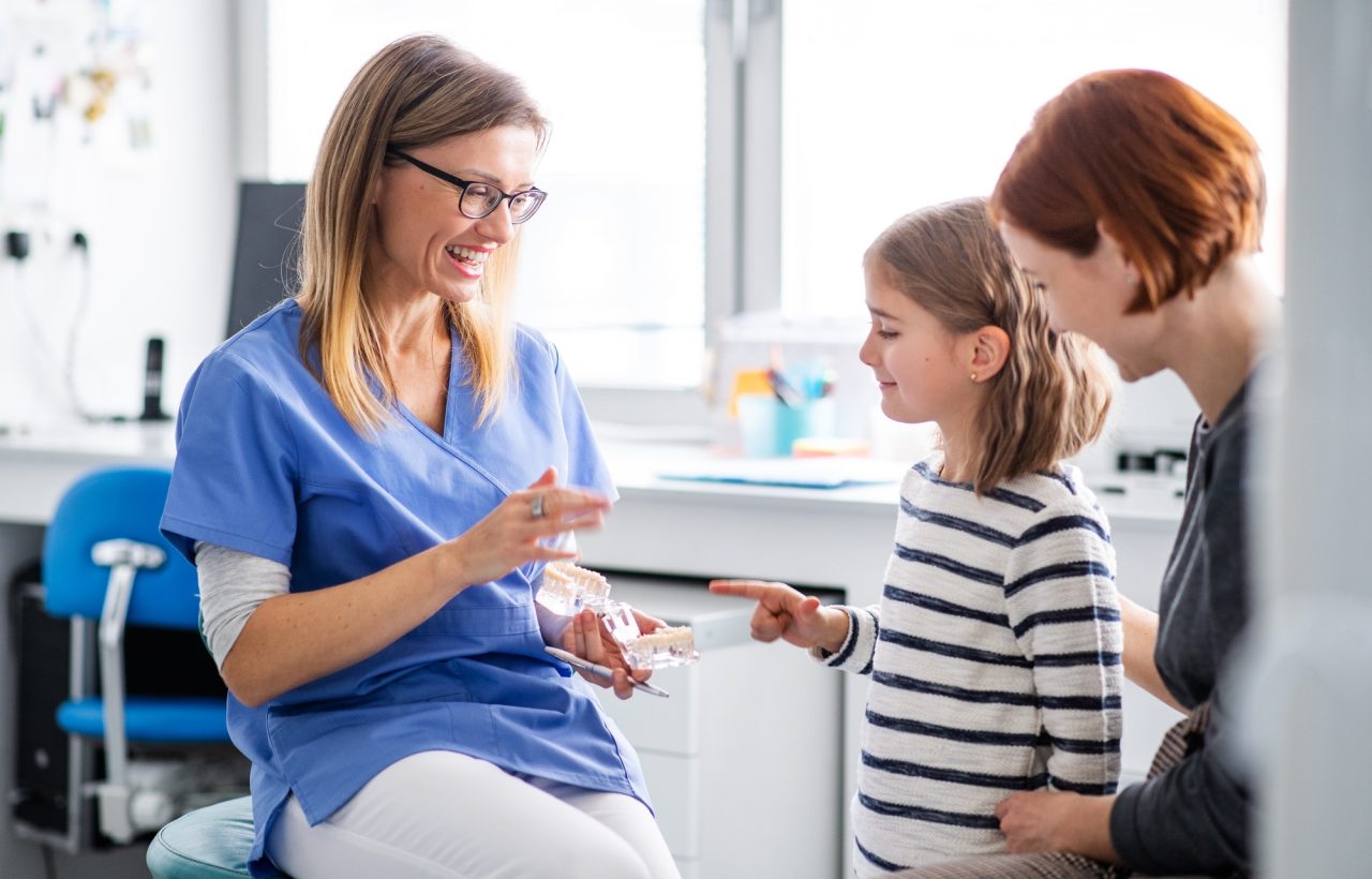 A small girl mother and dentist in surgery dental checkup.jpg