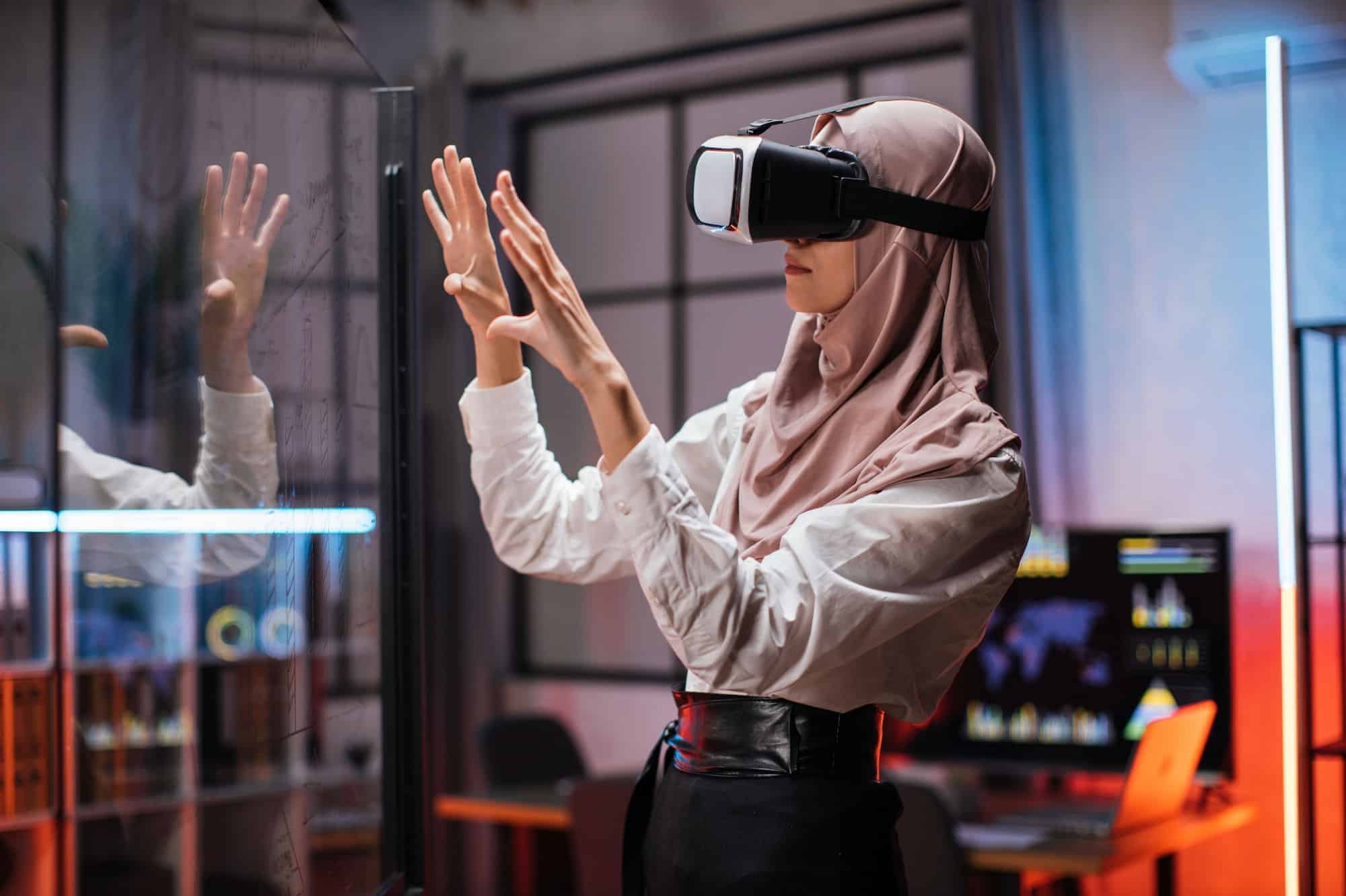 Confident muslim woman in hijab using innovative technology during business strategy 1 1.jpg